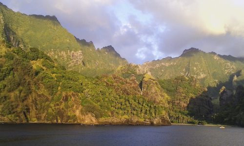 Hanavave harbour or Bay of Virgins on the island of Fatu Hiva in the Marquesas Islands, French Polynesia, sunset stop for Aranui 3 cargo cruise ship