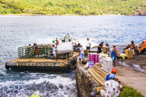 Loading cargo onto the raft to transport to the moored Aranui 3 cargo cruise ship in the Marquesas Islands