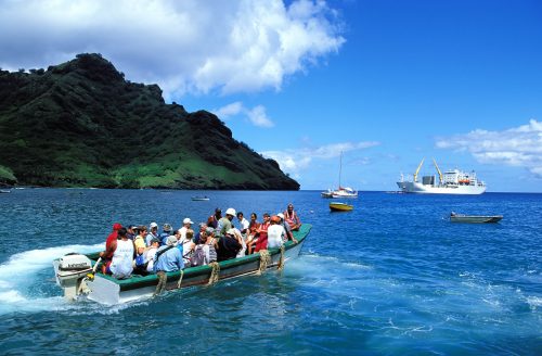 Boats transport passengers back to the Aranui 3 cruise and cargo ship which cannot always moor close to land