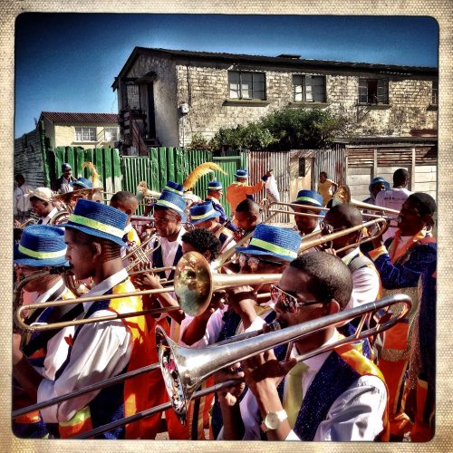 The Ken Fac troupe, from Kensington, marched through the streets of Parkwood before attending the final completion of the 2013 Minstrel Carnival in Athlone, Cape Town, South Africa. The day started great for Ken Fac placing second overall in the carnival but ended horribly when one of their members was stabbed to death on their bus en route to the after celebration. The stabbing was done by a group of youth trying to get a free ride on their bus that had no affiliation with them.