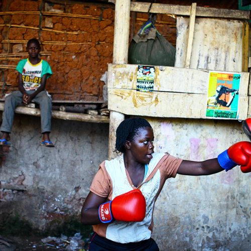 A female boxer trains inside a makeshift gym in Katanga, Kampala, Uganda.