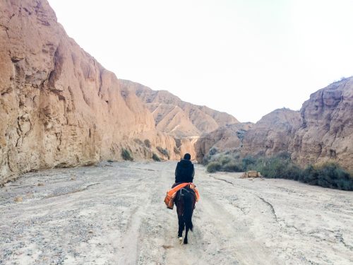 Horseriding through a rocky pass in Kyrgyzstan