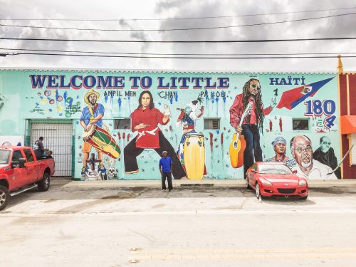 Artist Serge Toussaint stands in front of one of his bigger murals in Miami Florida's, Little Haiti.