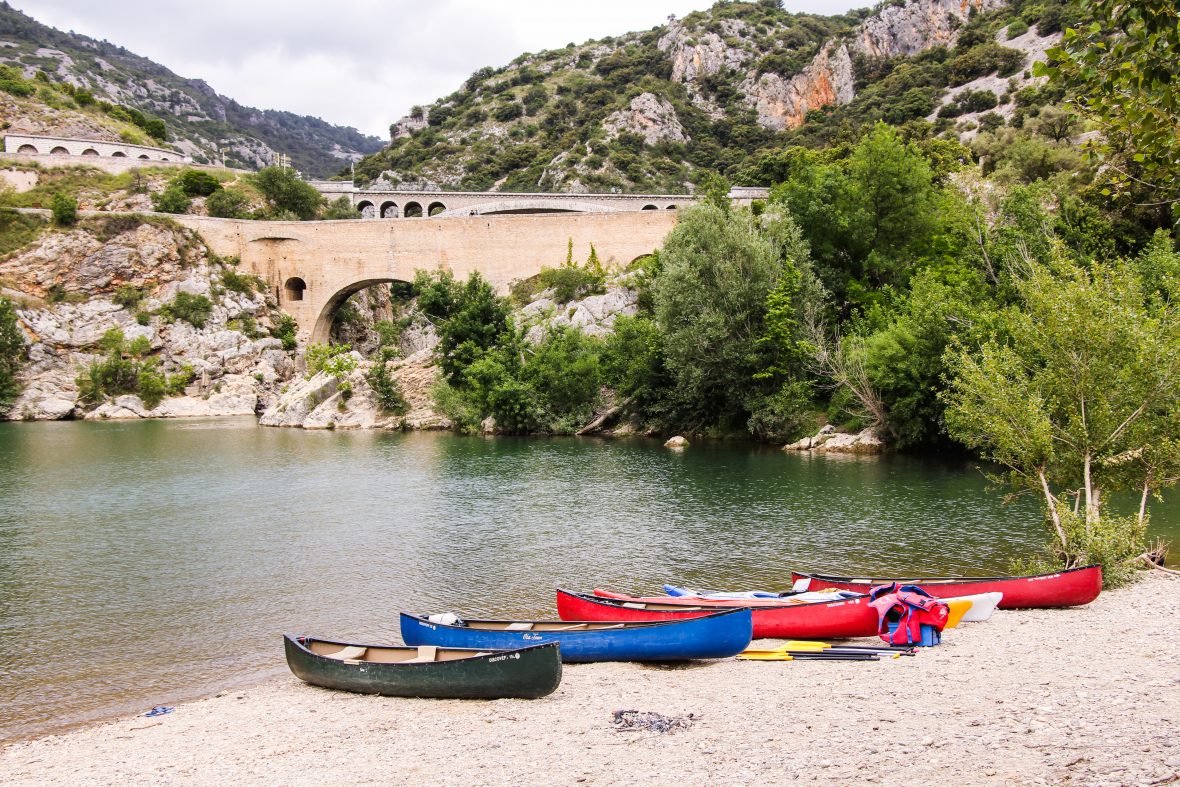 Brightly colored kayaks on the sand in the Vallée de l'Hérault: kayaking in France