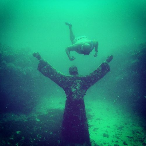 A snorkeler looks at one of the pieces in the underwater sculptural piece known as Vicissitudes by British artist Jason deCaires Taylor.