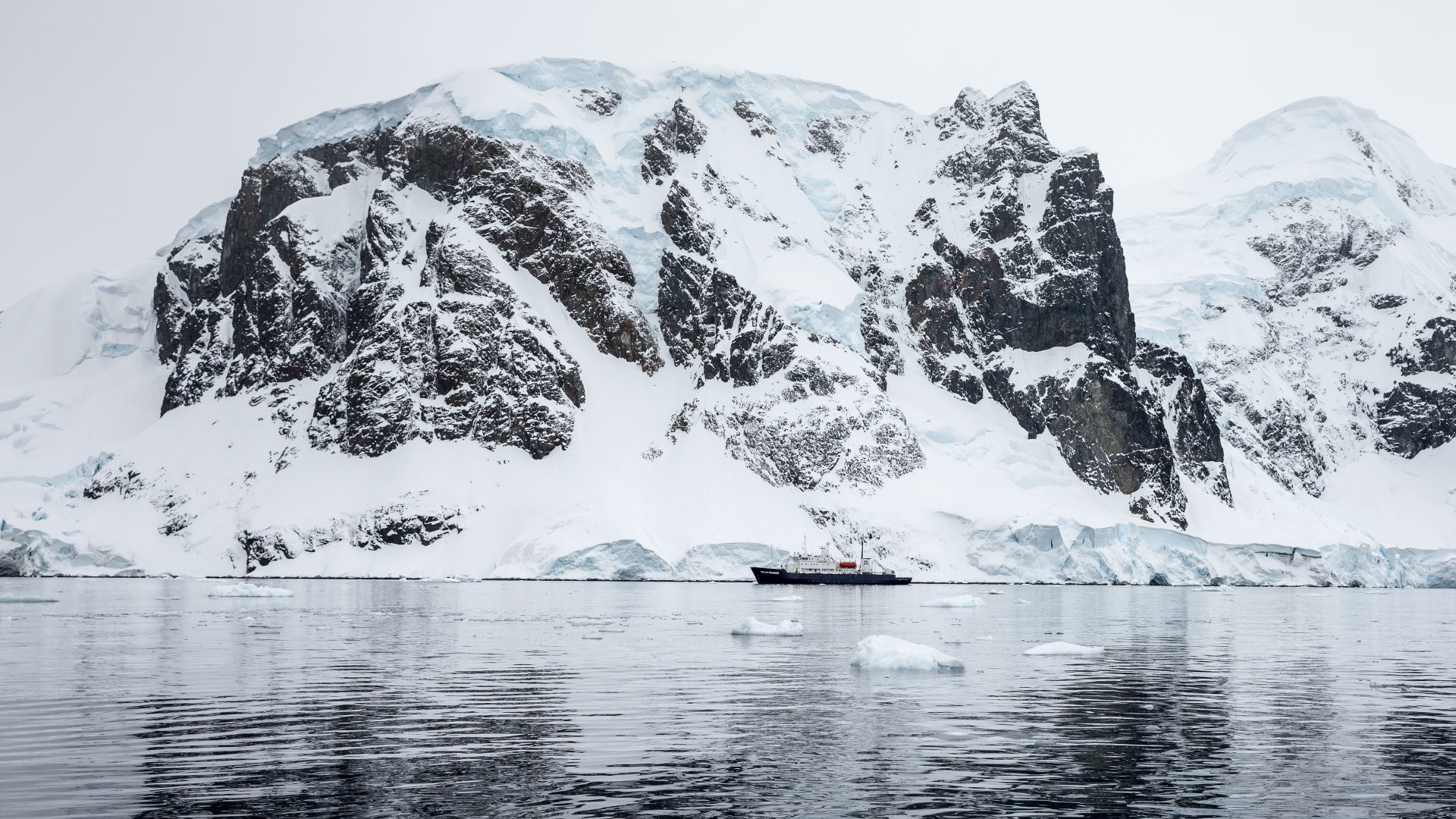 An iceberg reflected in the water of Antarctica.