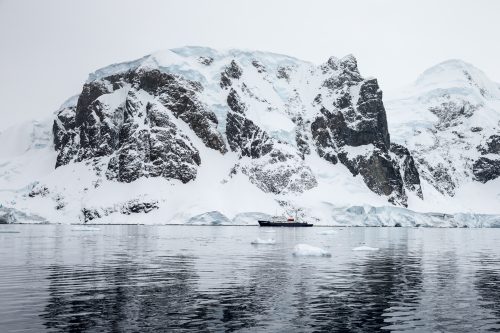 An iceberg reflected in the water of Antarctica.