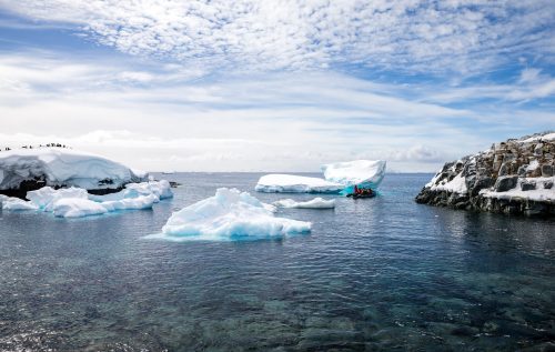 Zodiacs approach the icebergs in Antarctica.