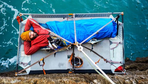 Travel writer James Stewart camping overnight on a portaledge above the sea in Rhoscoyne, north Wales. Photo: John Houlihan