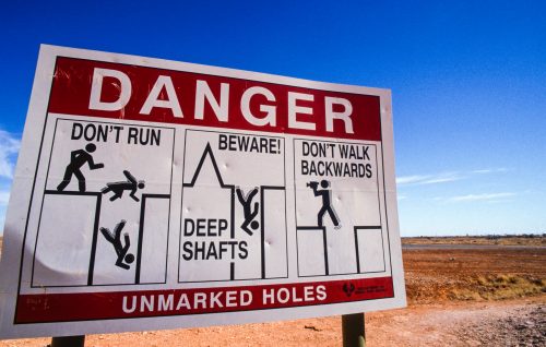 A sign in outback Australia warns of the dangers of walking backwards.