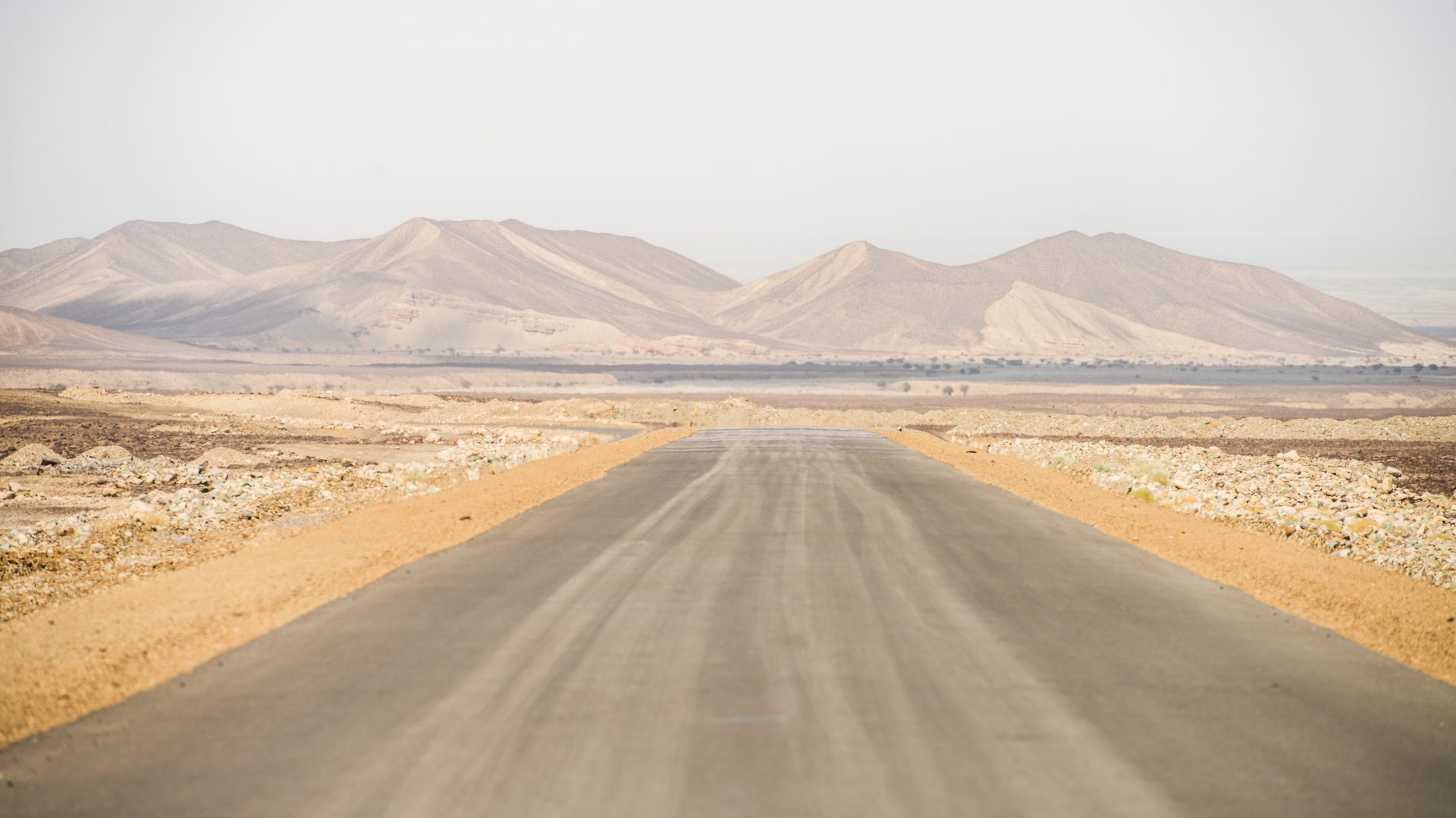 A road leads to arid mountains in the Danakil Depression, Ethiopia.