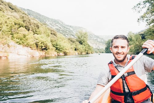 Max's face is visible as he kayaks down the river in Vallée de l'Hérault: kayaking in France