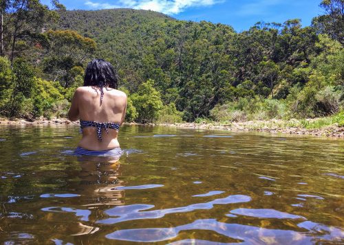 A woman swims in a fresh water hole in the outback, Australia.