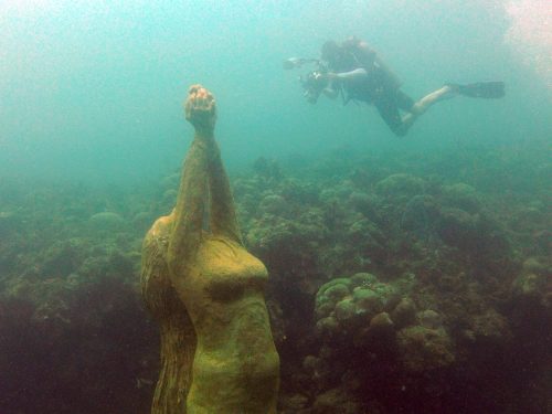 A snorkeler looks at one of the pieces in the underwater sculptural piece known as Vicissitudes by British artist Jason deCaires Taylor.