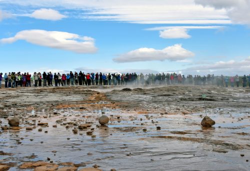 A crowd waiting waiting for the Strokkur Geyser eruption in Reykjavík, Iceland