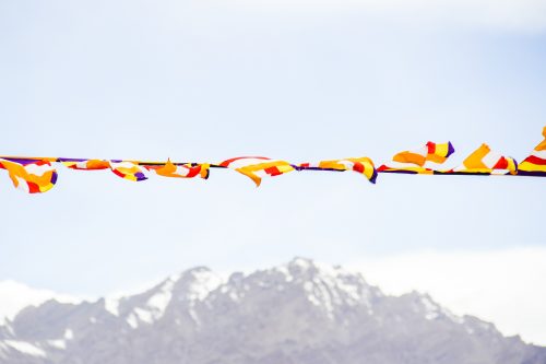 Prayer flags in the foreground and mountains in the background in Laddakh, Himalayas