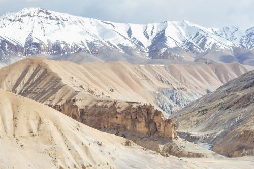The barren landscape backed by snowy mountains that's visble on the Manali - Leh Highway in the Himalayas