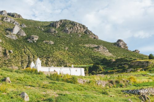 The view from Señor Pedro’s fields shows the Chivay Church. White, bright, and striking when it is against the green Andean highlands.