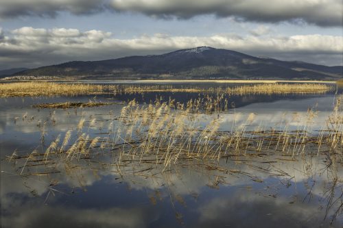 Cerknica intermittent lake with the background of Slivnica Mountain.