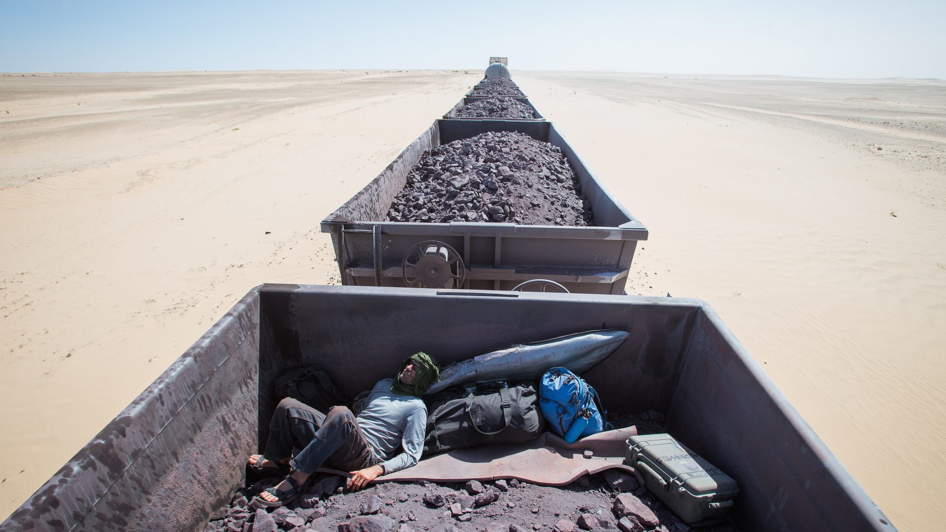 Train hopping on an iron ore train in search of surf in Mauritania. Africa
