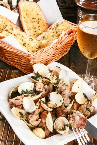 A typical dish from Portugal, Alenjejo pork with clams and a side of bread