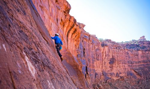 A rock climber scales a rock face