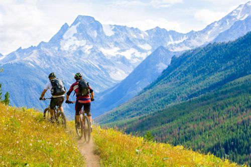 Photo: istock/GibsonPictures - Two mountain bike riders enjoy a cross country trail in British Columbia, Canada.