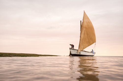 An Imragruen fisherman pulls up his nets onto his traditional fishing boat in Banc d’Arquin National Park, Mauritania.