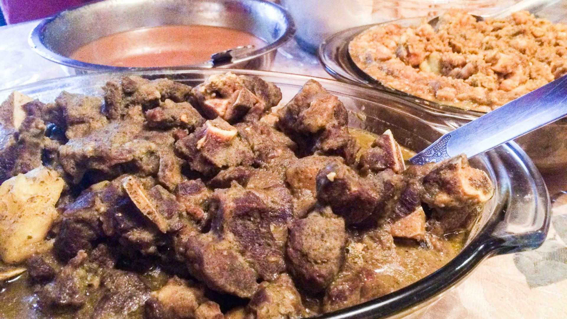Trini curry goat chana is served with aloo dahl and roti in South Ozone Park, Queens.