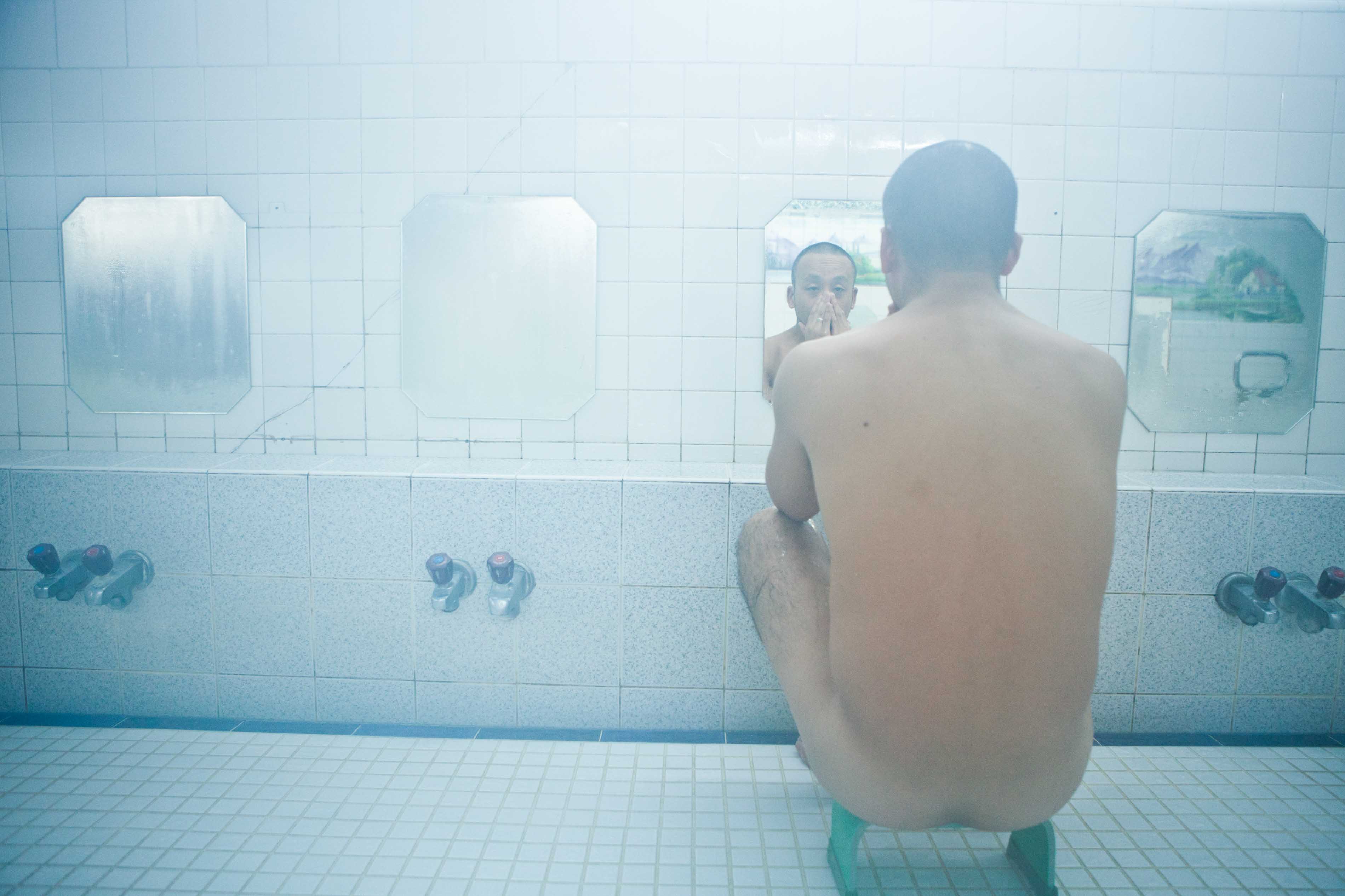 Japanese man bathing at traditional Onsen. 