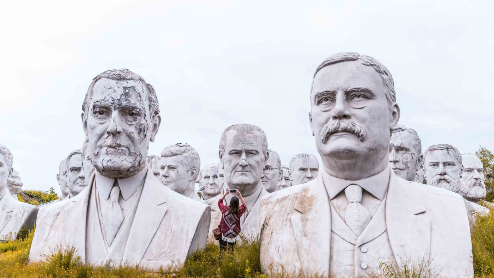 A woman can be seen taking photos of the busts or former US presidents which occupy the land of Croaker farmer Howard Hankins in rural Virginia.