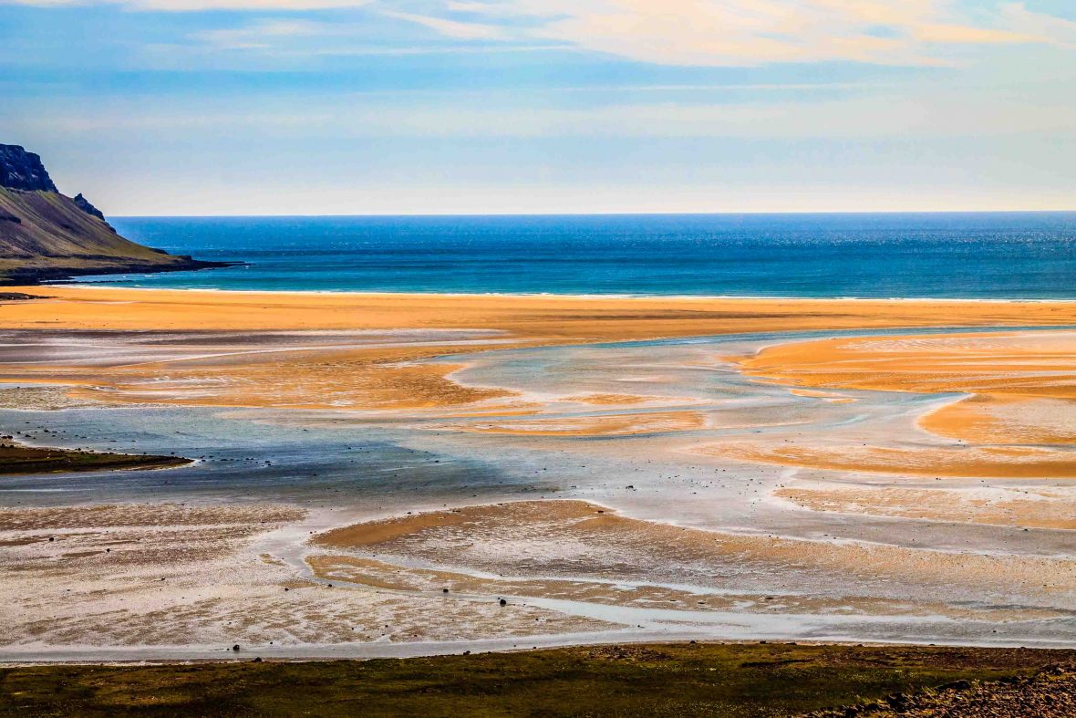 The red sands of Rauðasandur, Iceland, look surreal against the blue sky.