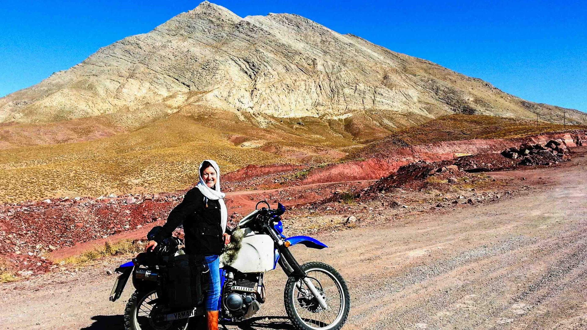 Lois by her bike in the desert mountains of Iran.