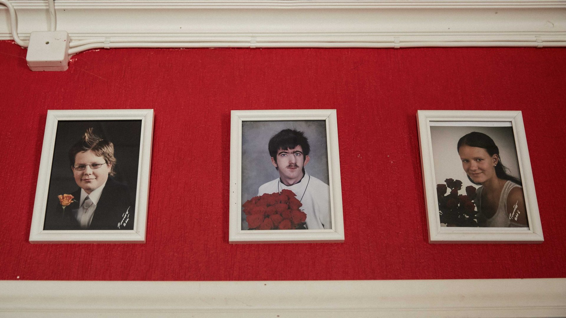 Photos hang on the wall of Mirtsu and Sirppi's home in Tuusula, southern Finland.