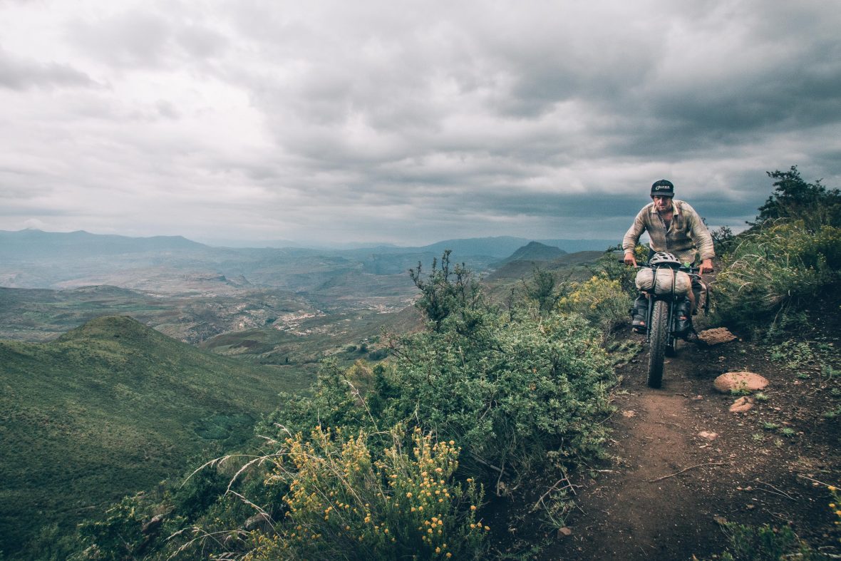Ben rides along a precarious single track in Lesotho.