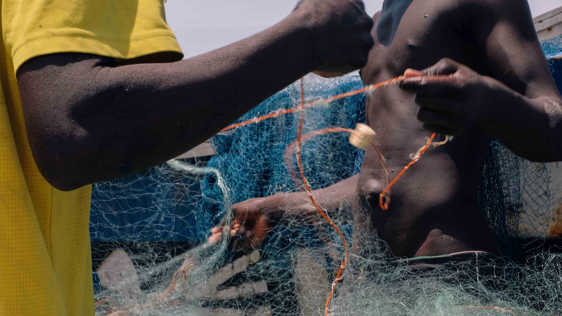 Local fisherman making nets in Jamestown, Accra, Ghana.