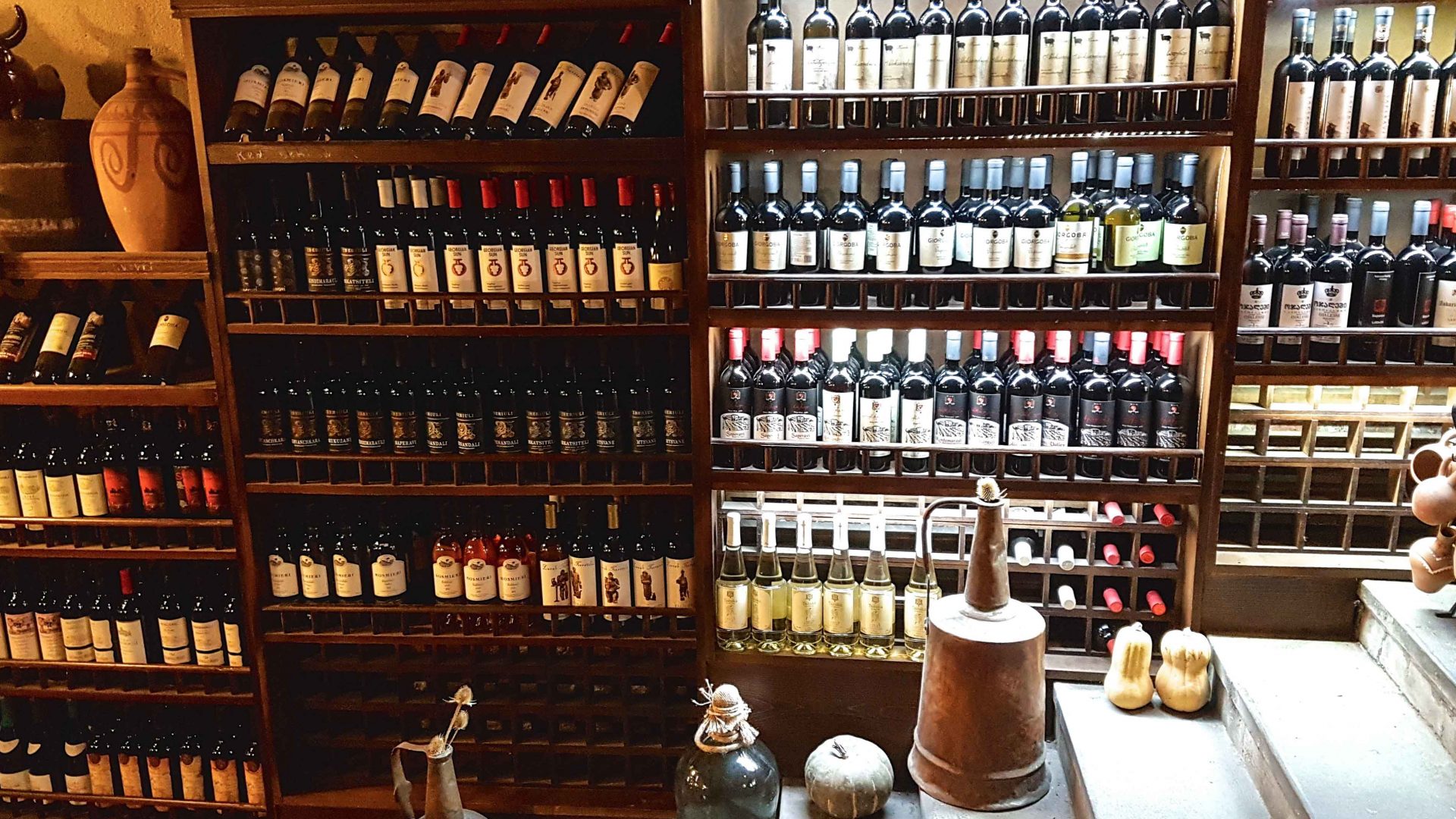 Famous Georgian natural wines displayed on a shelf.