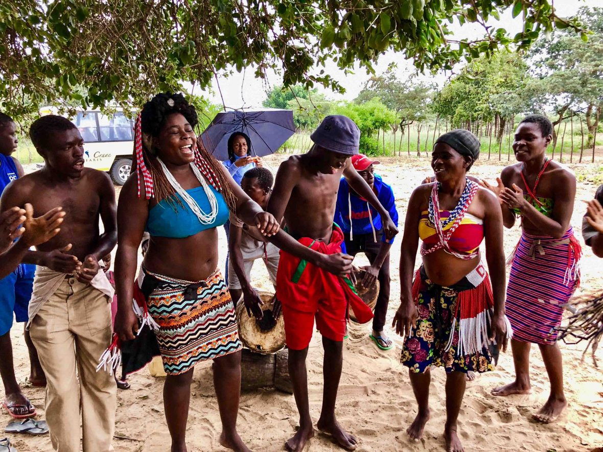 At a village near the Okavango River, residents gather and put on an impromptu show, pounding on drums and singing and dancing with passion.
