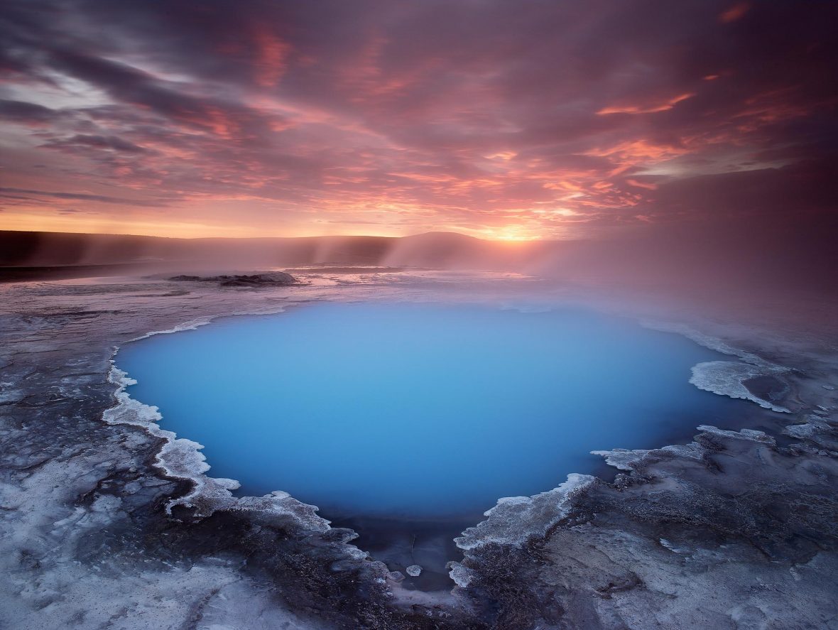 A small geothermal pool at sunrise in midsummer in Hveravellir in Iceland's remote central highlands.