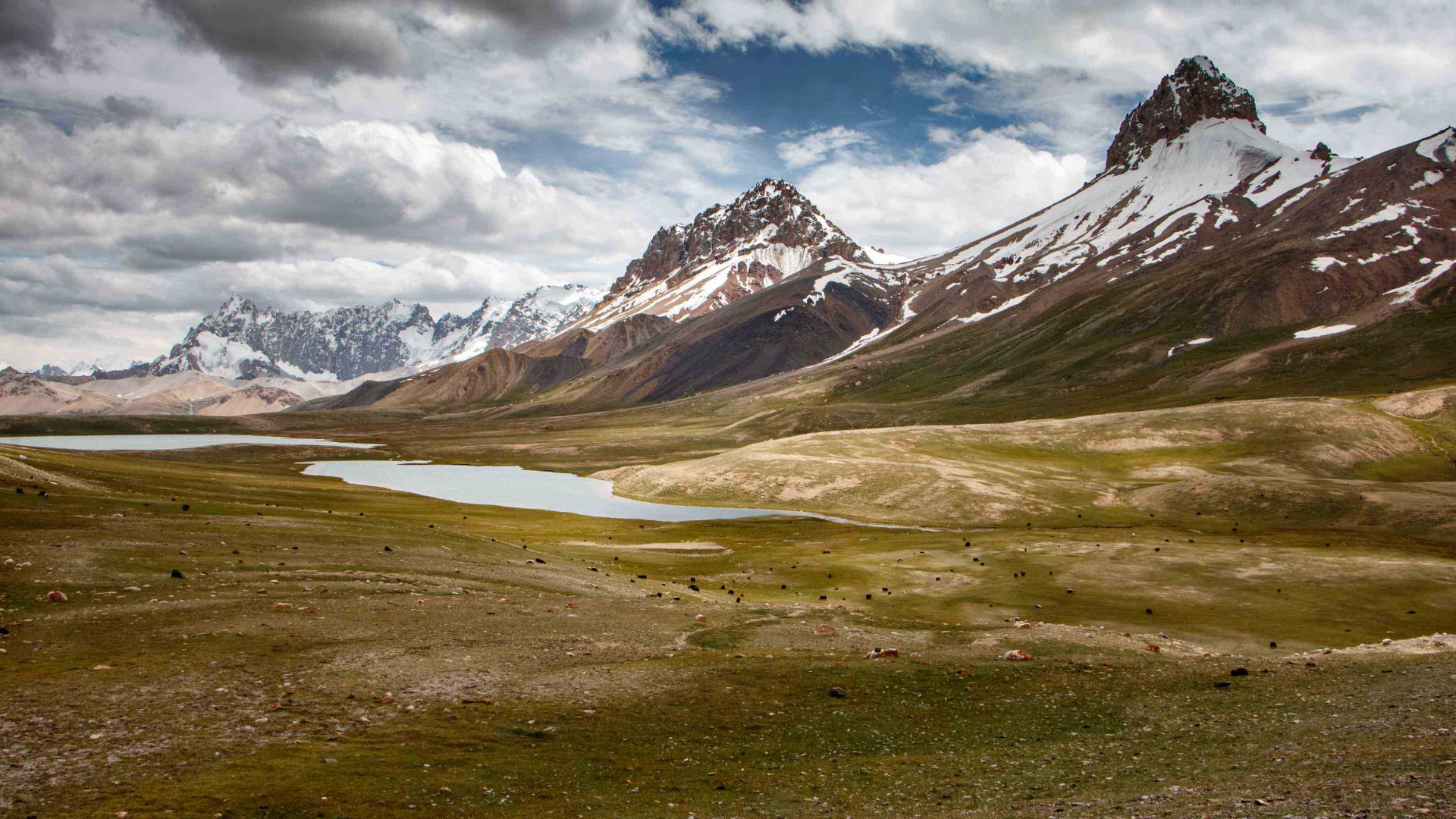 Below the 6,000-meter-high Karakoram mountains sits the Pamir plateau where yaks graze by high-altitude meadow and lakes.