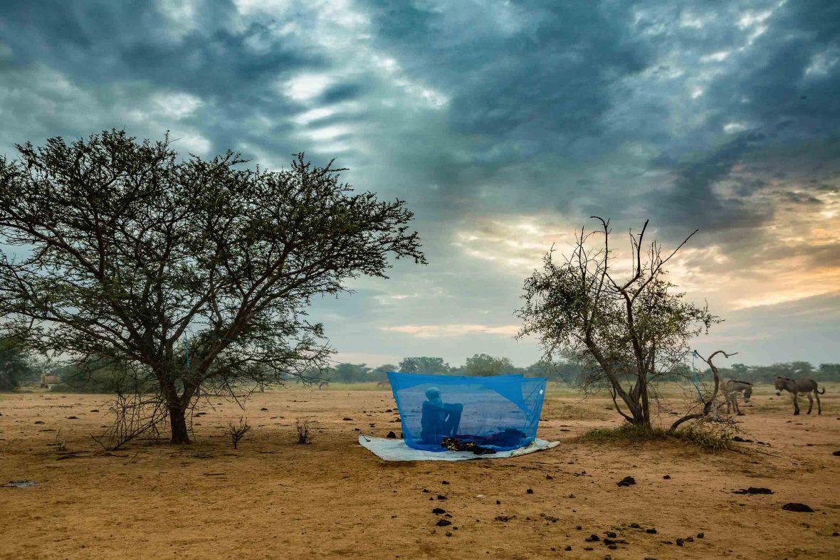 A Wodaabe man wakes as dawn breaks in the Sahel desert.
