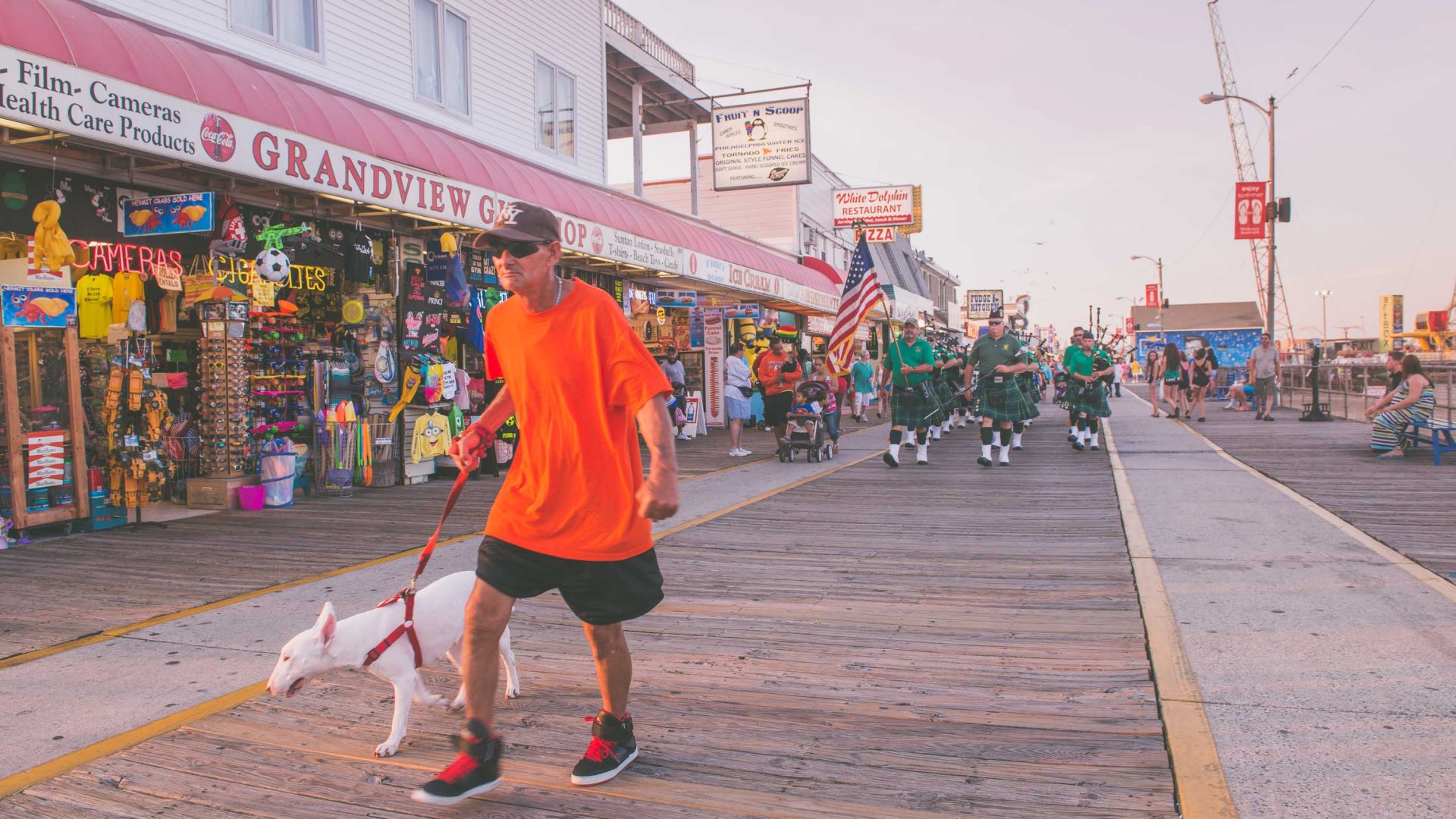 A man walks his dog along the boardwalk at Wildwood, New Jersey.