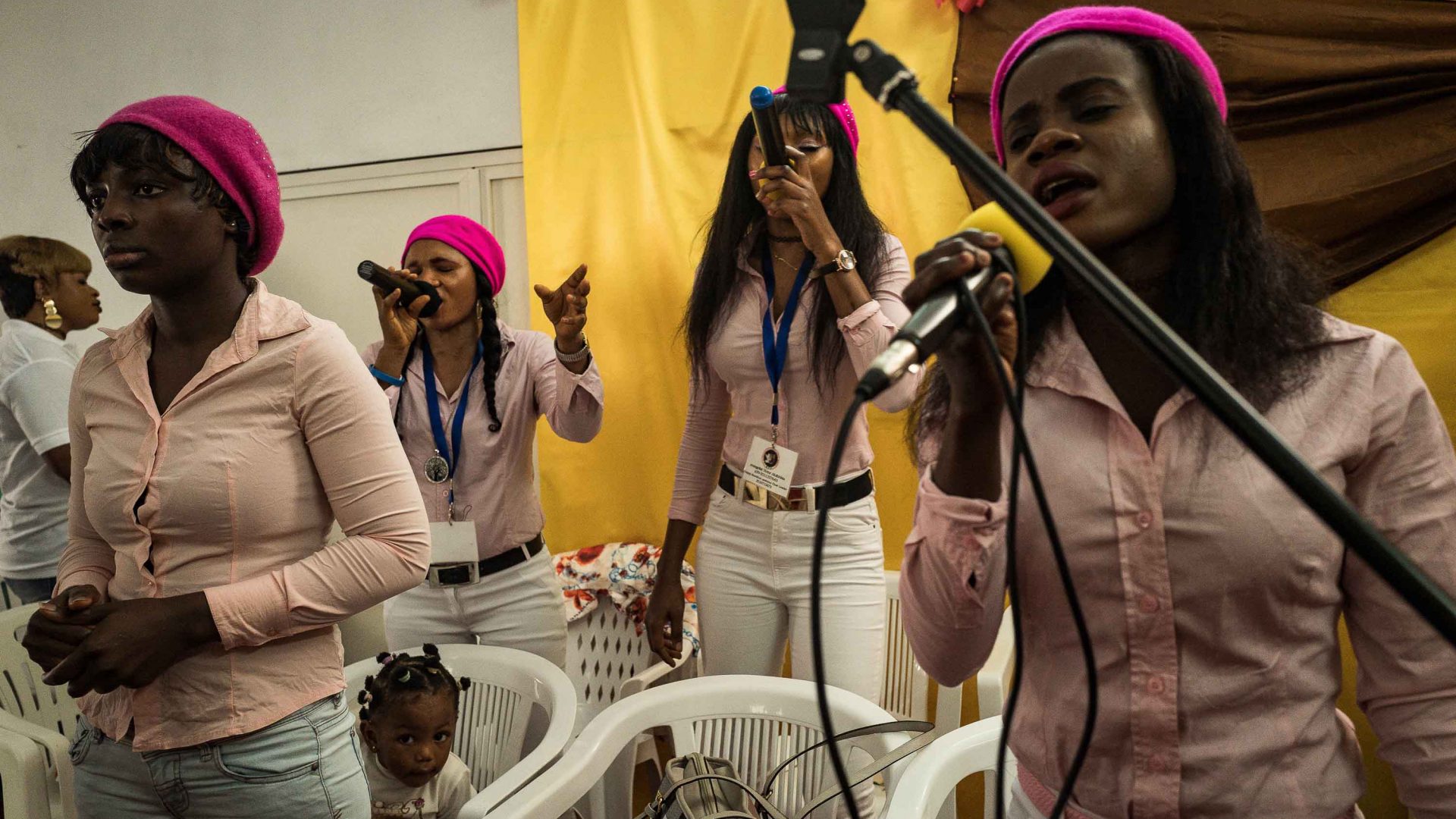 Nigerian women singing gospel at the ‘salvation evangelical church’ of Riace for the Sunday mass.