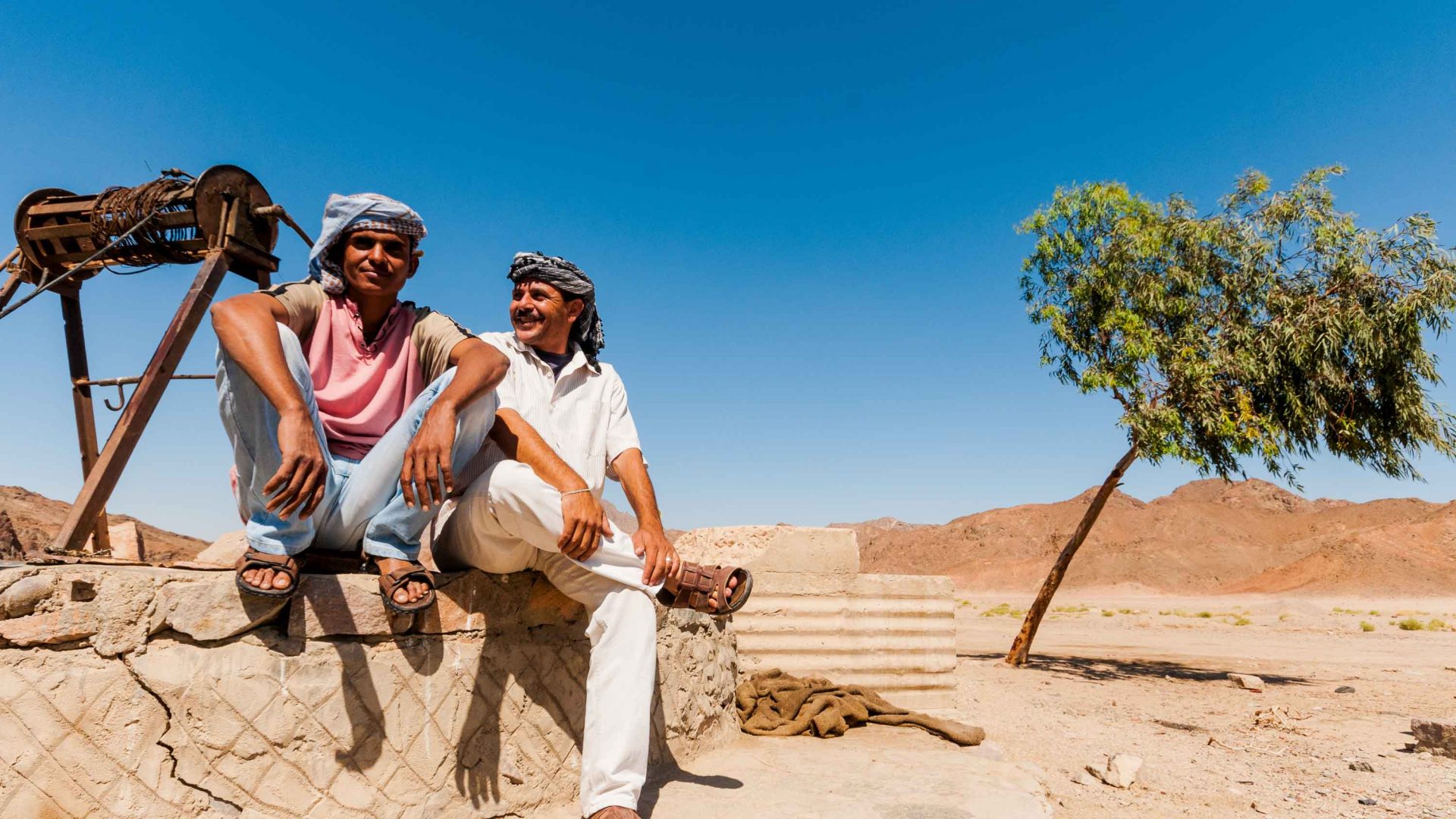 Local members of our support crew rest by a well in the middle of the Eastern Desert.