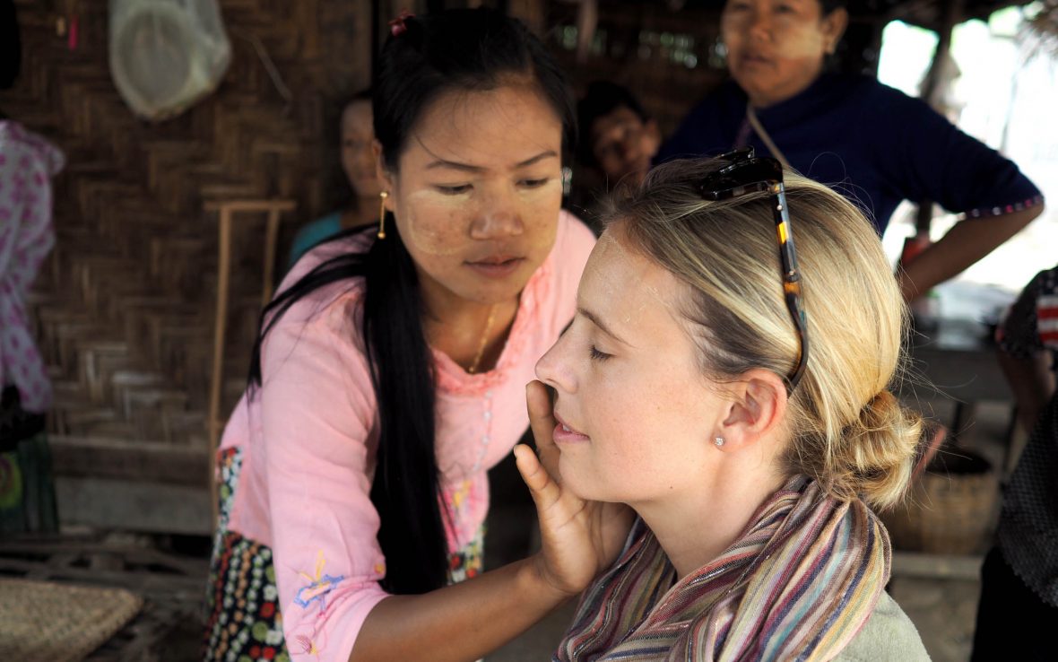 A traveler and local woman in the Myanmar's Myaing village share a community-based tourism experience.