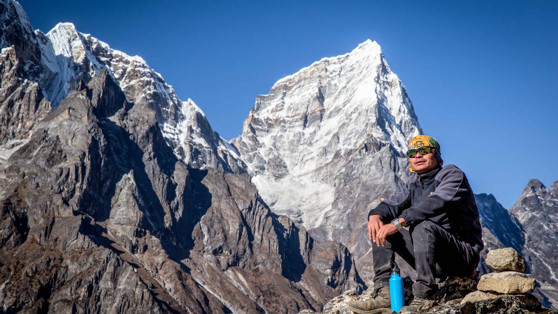 A porter relaxes and enjoys the view during the Everest Base Camp trek.