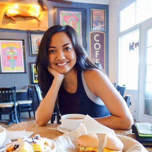 Writer Ligaya Malones smiling to camera at a cafe