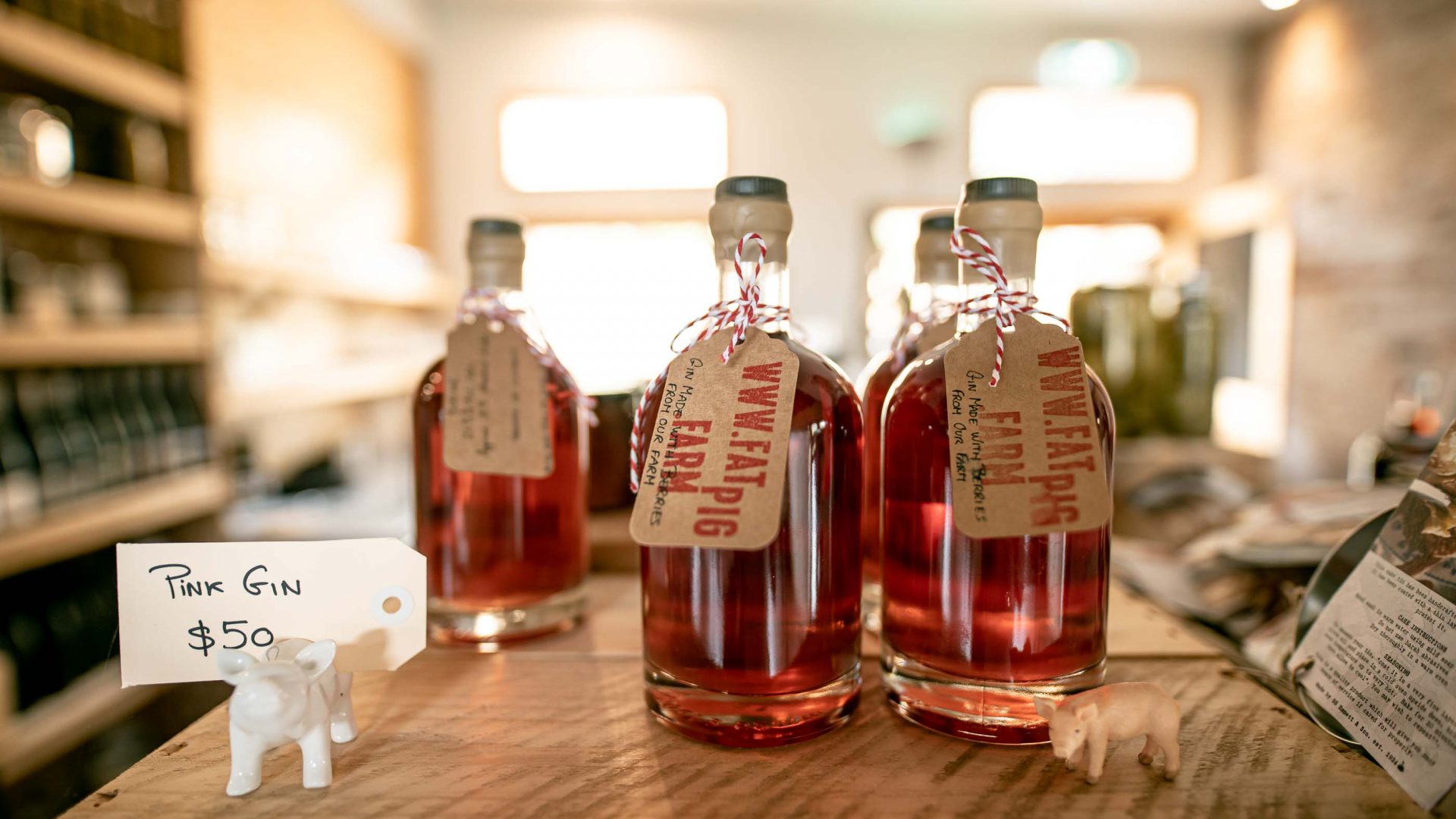 Bottles of pink coloured gin for sale.