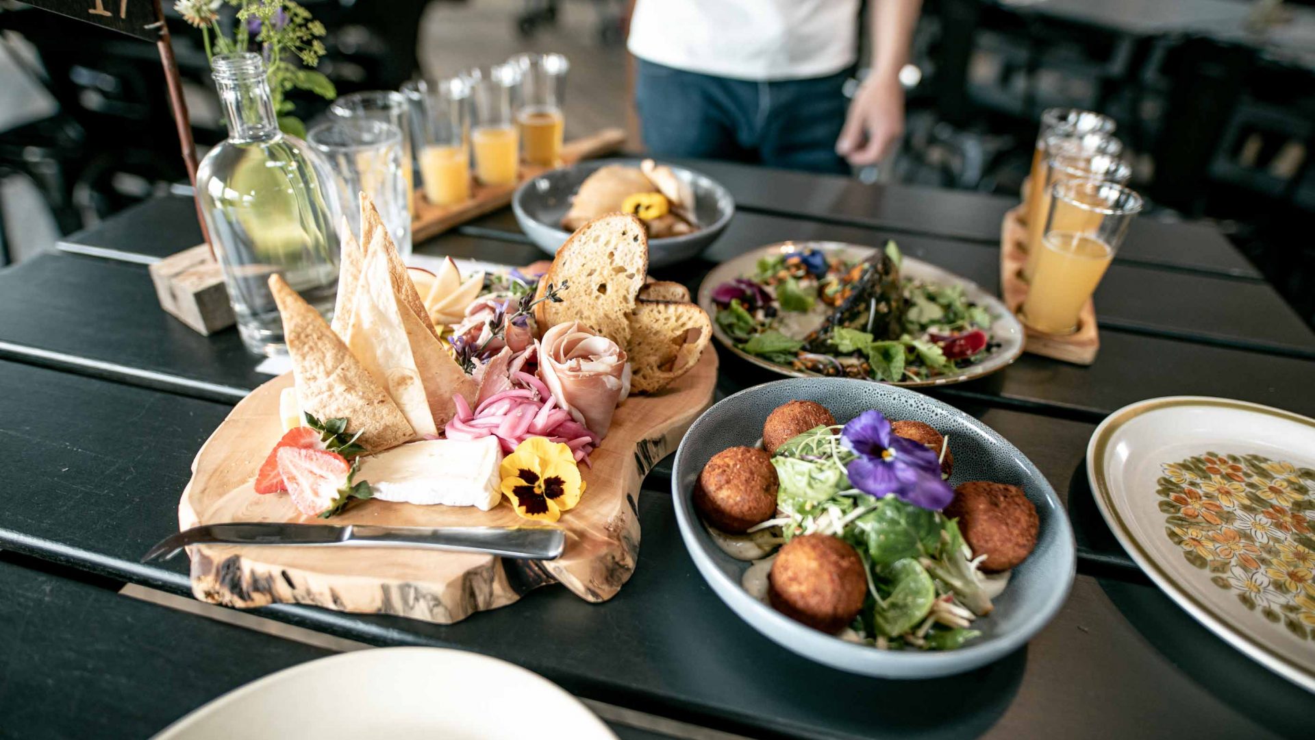 A feast of fresh food and drinks on a wooden table.