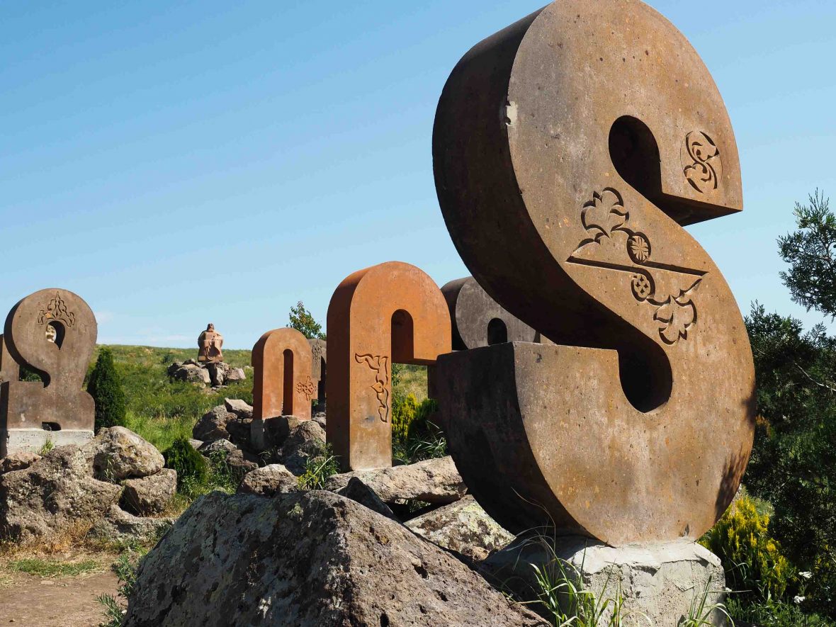 Letters of the Armenian alphabet dot the landscape.